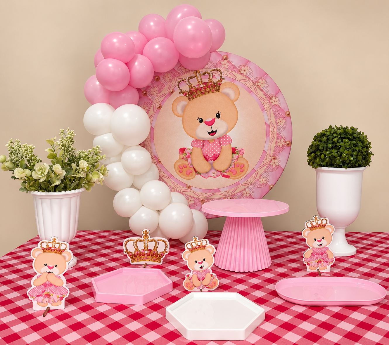 Mesa de festa com painel de ursinha rosa, balões, flores e suportes para doces