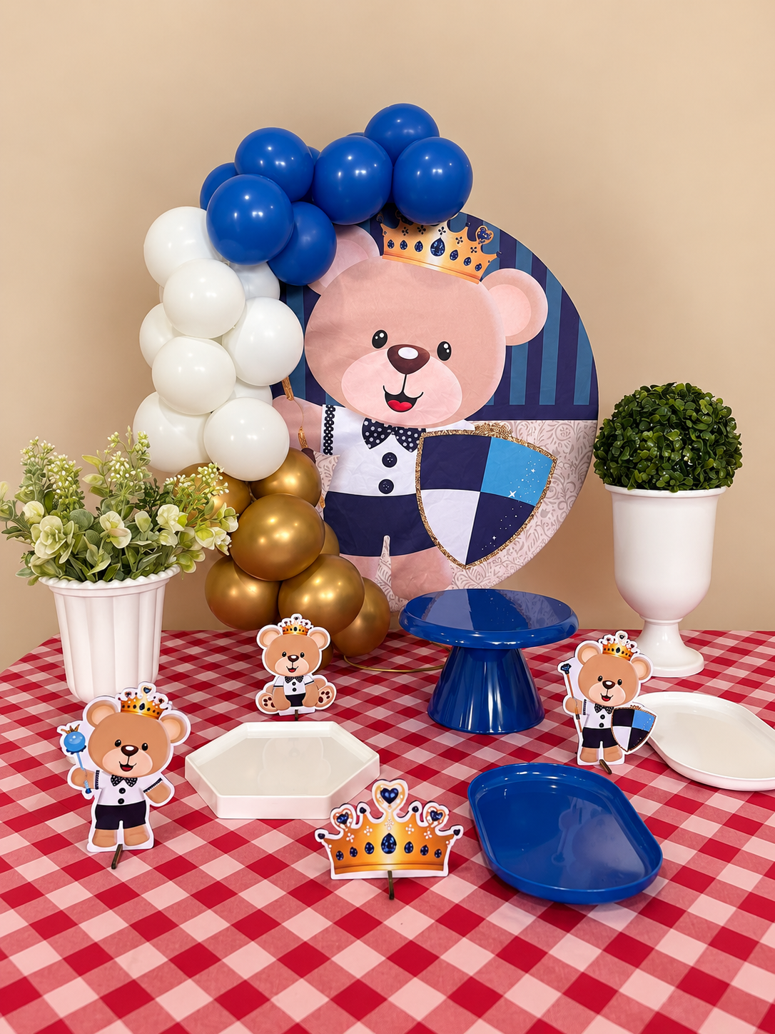 Mesa de festa com painel de ursinho azul, balões e suportes para doces